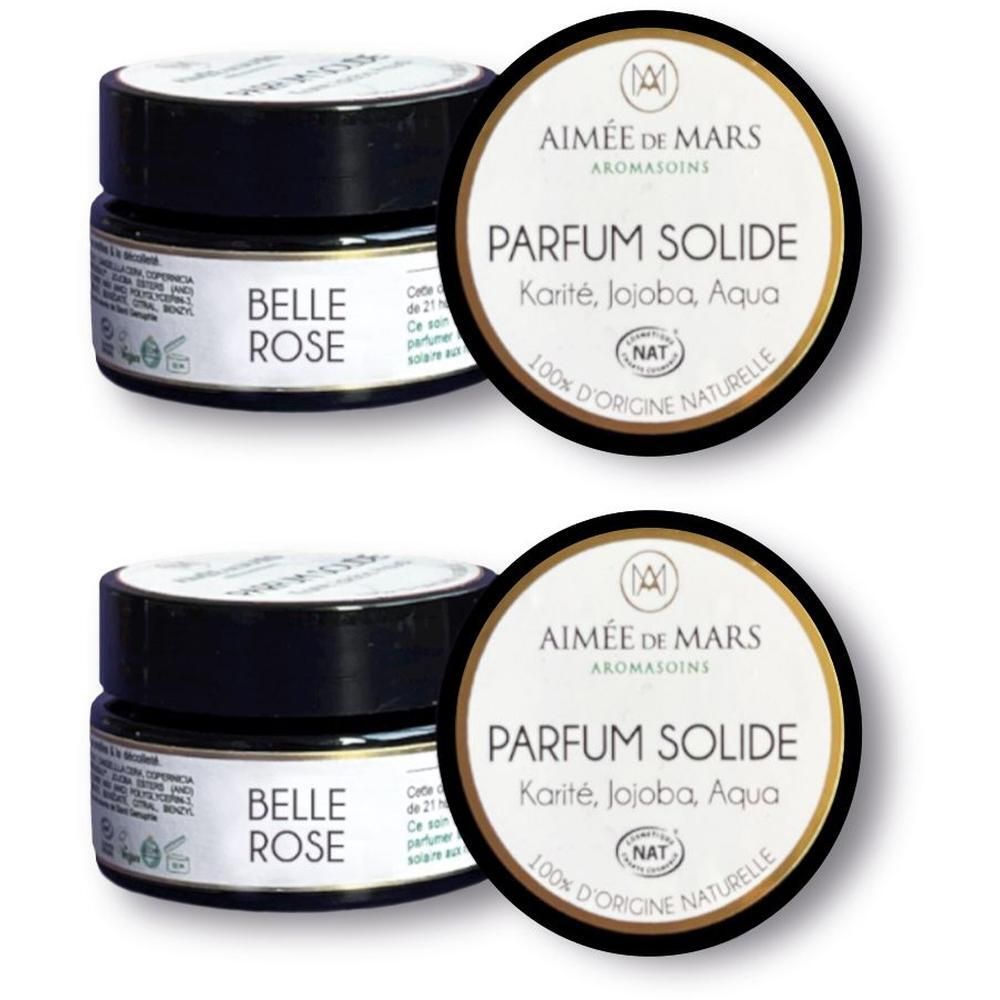Twee potjes vaste parfum met zwart deksel en etiket.