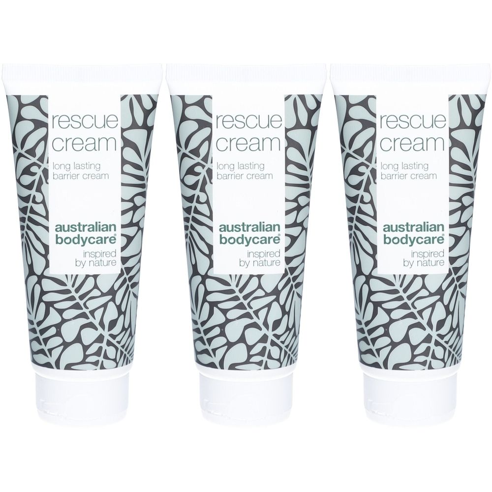 Trois tubes de crème avec bouchons blancs. Inscription: rescue cream, australian bodycare. Motif de fond avec des feuilles.