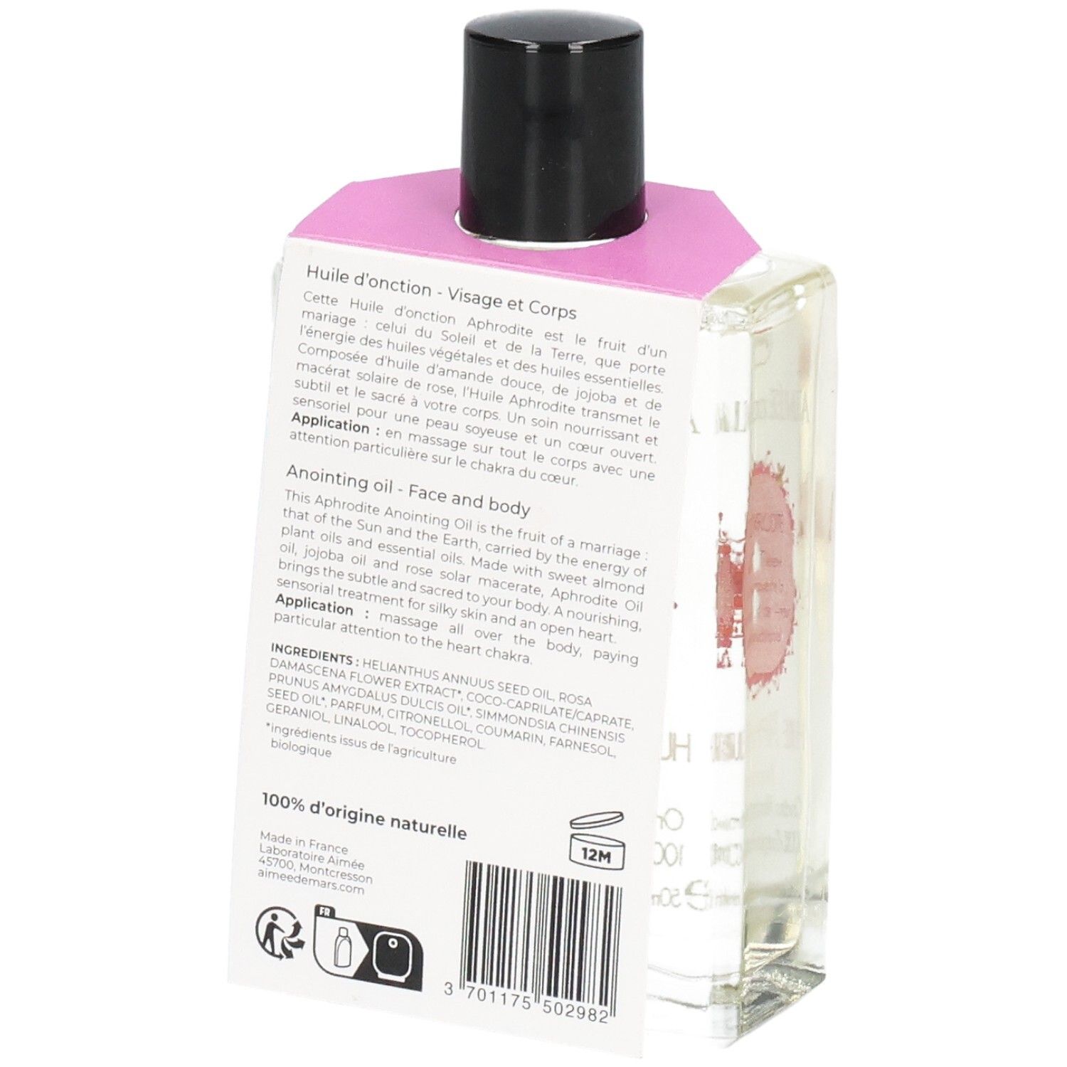 Glazen fles met heldere vloeistof, zwarte dop en roze etiket. Achterkant met tekst en barcode.