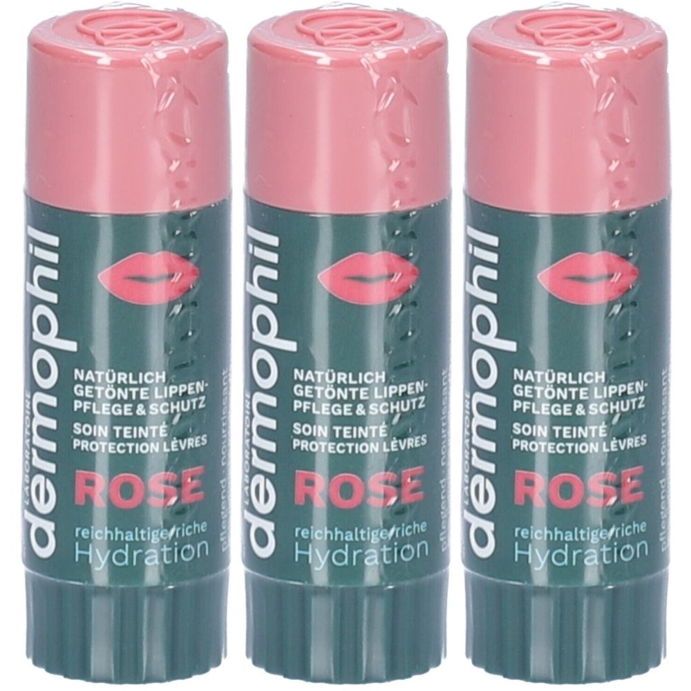 Drie lippenstiften met roze dop en huls. Opschrift: Dermophil, Rose, getinte lippenverzorging & bescherming. Verpakt in folie.
