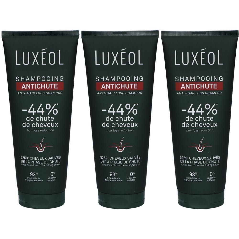 Trois tubes de shampooing LUXÉOL antichute. Tubes noirs avec texte blanc et accent rouge. -44% de chute de cheveux.