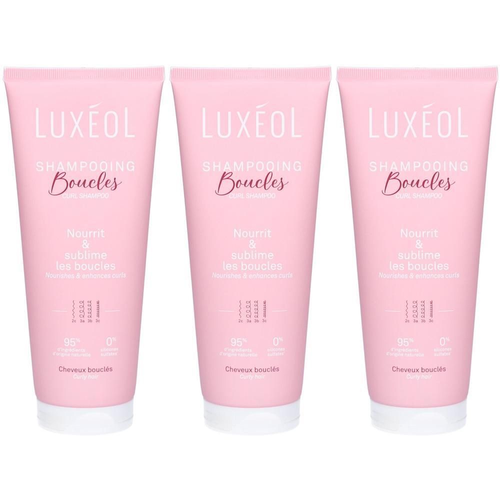 Trois tubes roses de shampooing LUXÉOL Boucles. Texte: Nourrit & sublime les boucles. Pour cheveux bouclés. 95% ingrédients naturels.