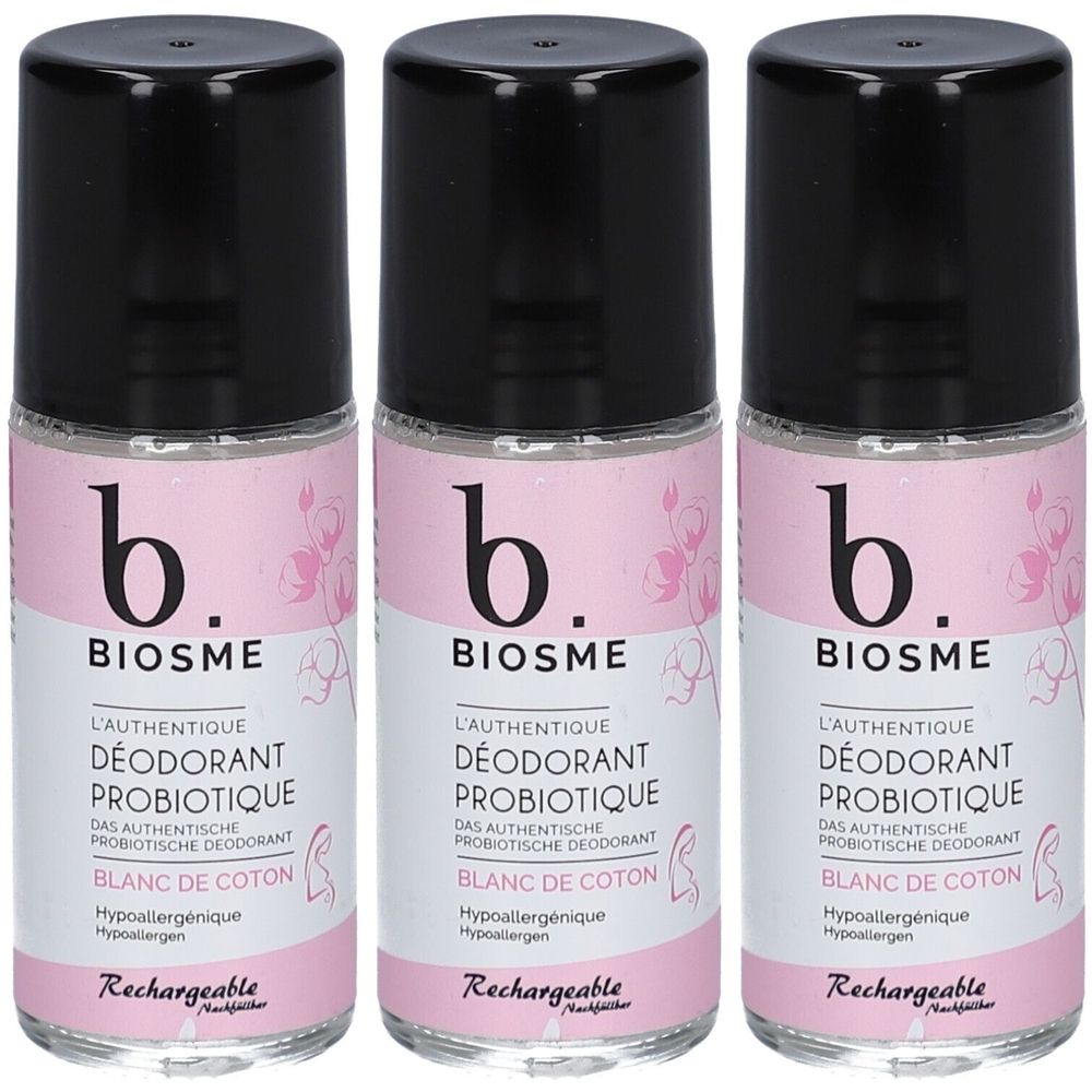 Drie roll-on deodorants. Opschrift: b. BIOSME, L'AUTHENTIQUE DÉODORANT PROBIOTIQUE, BLANC DE COTON. Zwarte dop, roze etiket met bloemmotief.