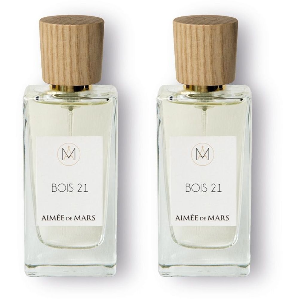 Deux flacons rectangulaires en verre avec bouchons en bois. Étiquette : Bois 21, Aimée de Mars et logo. Fermeture dorée.