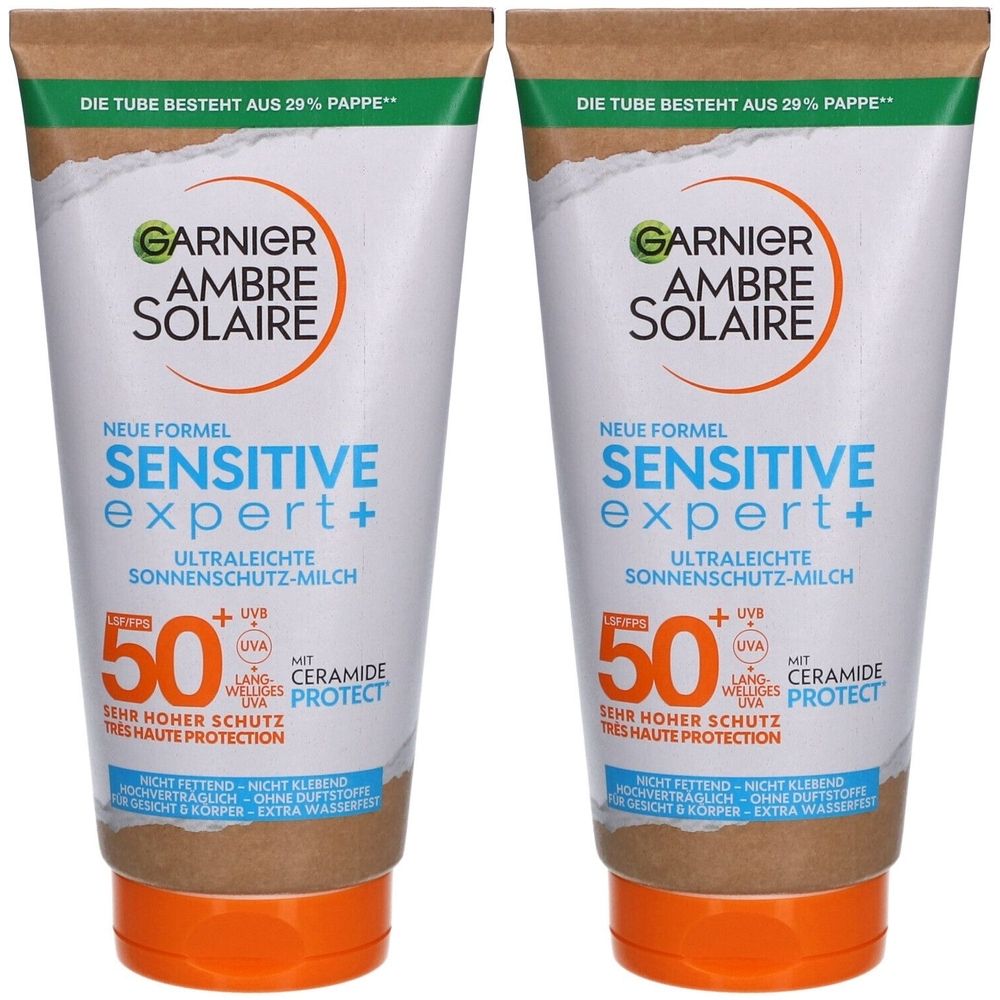 Deux tubes de lait solaire Garnier Ambre Solaire Sensitive Expert+ SPF50+. Tubes blancs avec accents marron et orange. Texte : 'Très haute protection'.