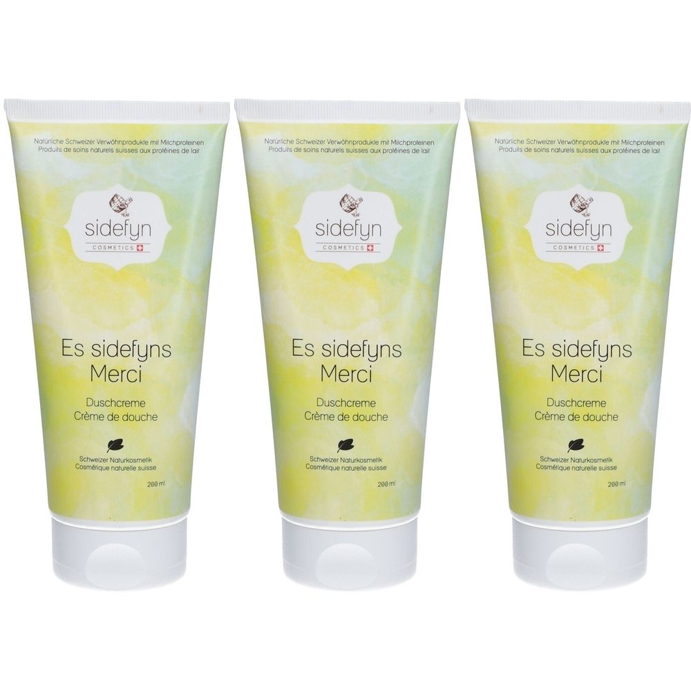 Drie tubes douchecrème met productnaam en logo. Kleurovergang van geel naar groen. Tekst: Es sidefyns Merci, Crème de douche.