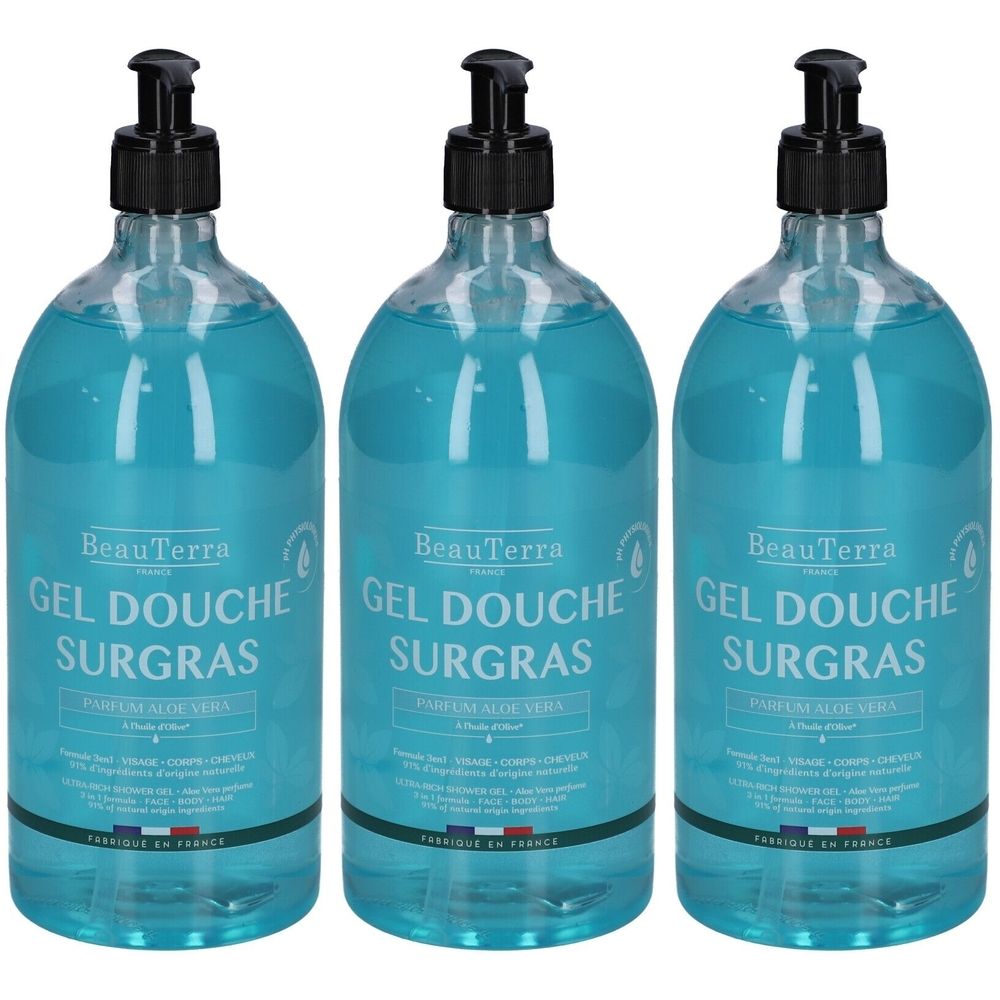 Drie flessen douchegel met zwarte pomp. Opschrift: Gel Douche Surgras, Parfum Aloe Vera. Gemaakt in Frankrijk.