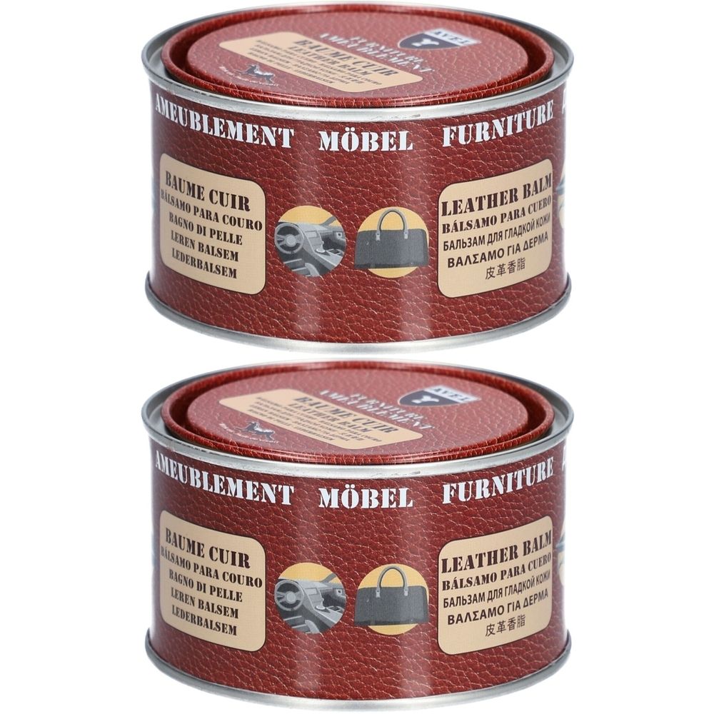 Twee blikken lederbalsem. Rode deksels en blikken met meertalige tekst. Opschrift: MÖBEL, FURNITURE, LEATHER BALM.