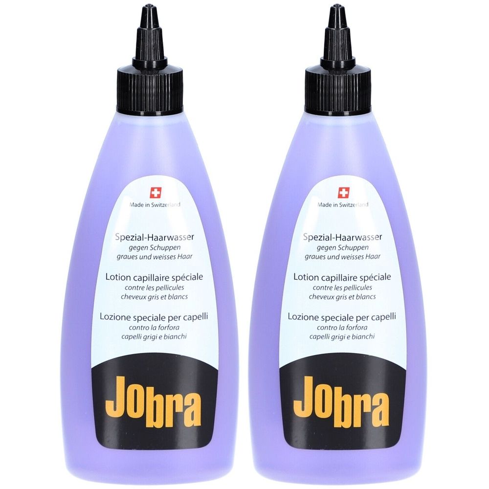 Twee paarse flessen met zwarte dop. Opschrift: Jobra, Spezial-Haarwasser tegen roos. Zwitsers kruis.