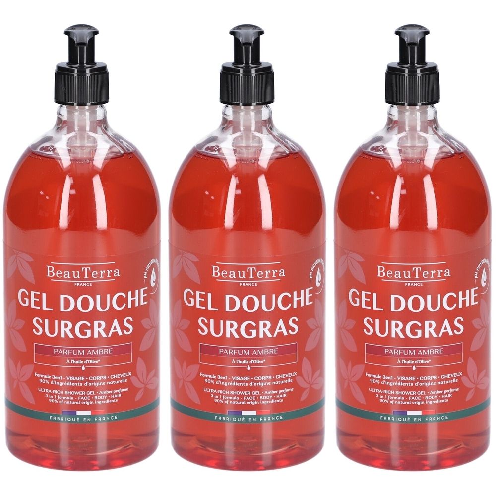 Drie flessen douchegel met zwarte pomp. Opschrift: BeauTerra, Gel Douche Surgras, Parfum Ambre.