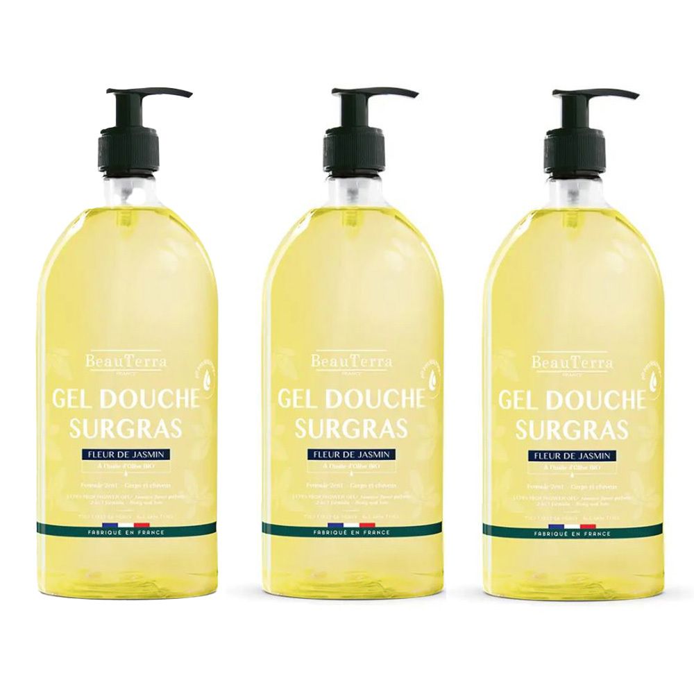 Drie flessen douchegel met zwarte pomp. Opschrift: GEL DOUCHE SURGRAS, FLEUR DE JASMIN. Gele vloeistof, groene en witte etiketten.