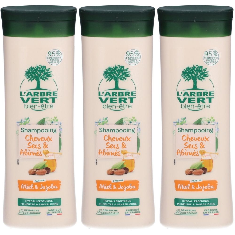 Drie shampoo flessen met groene dop. Opschrift: L'ARBRE VERT bien-être, Shampooing Cheveux Secs & Abimés, Miel & Jojoba.