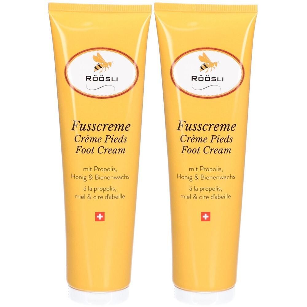 Deux tubes jaunes de crème pour les pieds RÖÖSLI. Inscription : Fusscreme, Crème Pieds, Foot Cream. Avec propolis, miel et cire d'abeille. Croix suisse.