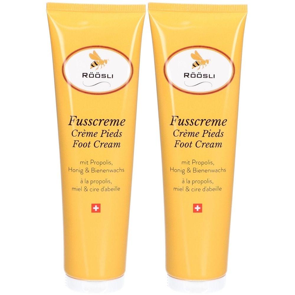 Deux tubes jaunes de crème pour les pieds RÖÖSLI. Inscription : Fusscreme, Crème Pieds, Foot Cream. Avec propolis, miel et cire d'abeille. Croix suisse.