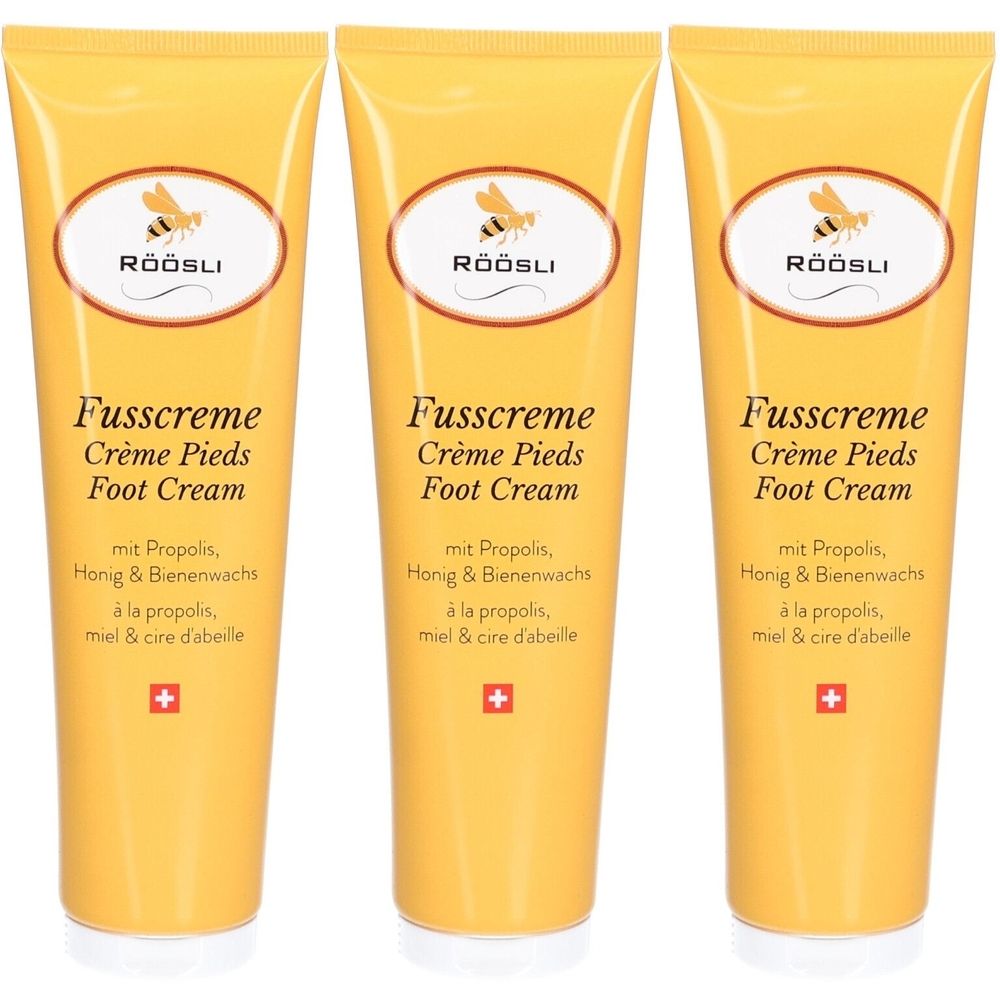 Trois tubes de crème pour les pieds jaunes. Chaque tube porte les inscriptions "RÖÖSLI", "Fusscreme", "Crème Pieds", "Foot Cream" et autres.