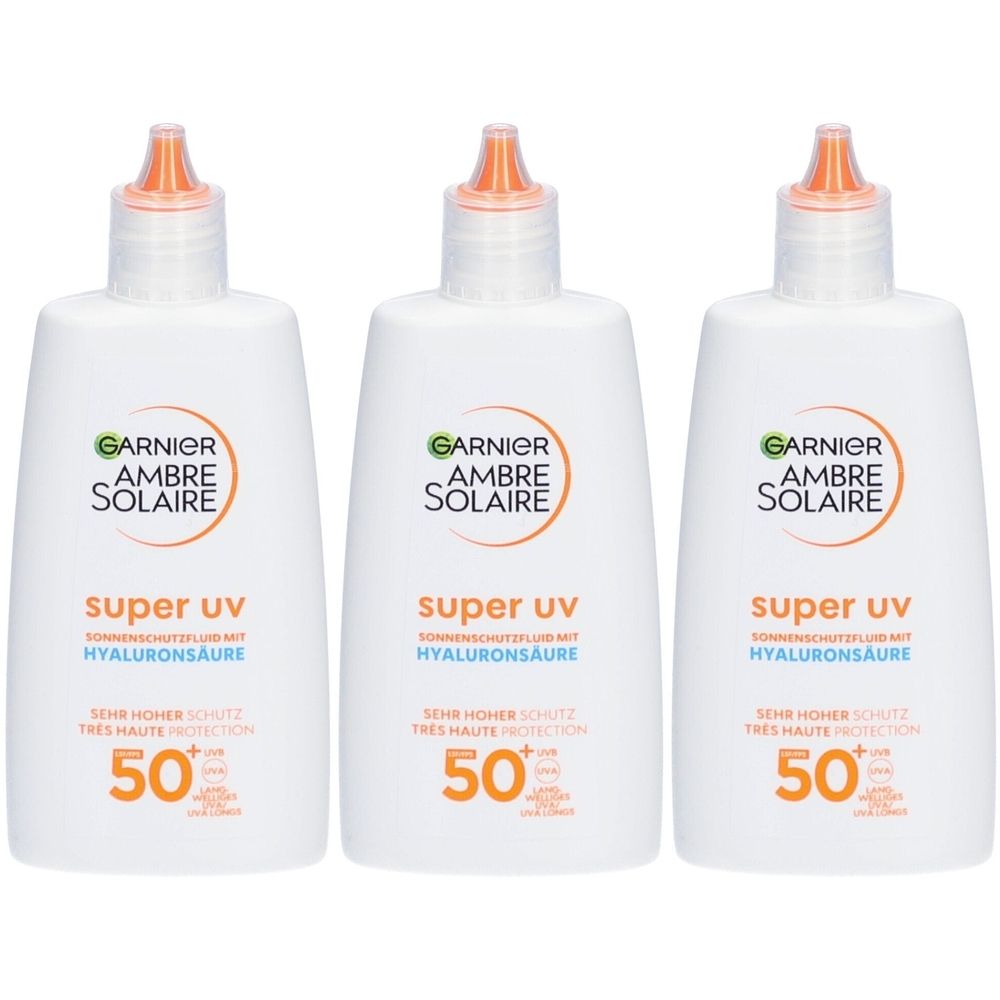 Trois flacons Garnier Ambre Solaire Super UV Fluide de protection solaire SPF 50 avec acide hyaluronique.
