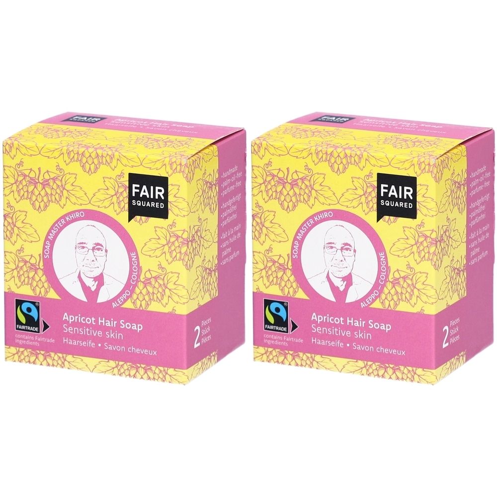 Twee vierkante dozen met FAIR SQUARED logo. Opdruk: Abrikoos Haarzeep, gevoelige huid. Met Fairtrade-keurmerk en afbeelding van een persoon.