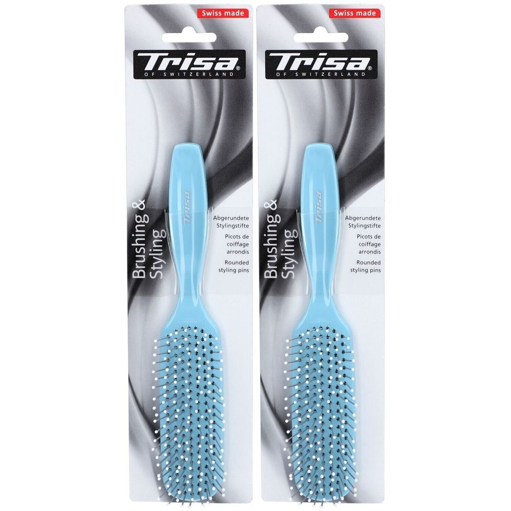 Twee blauwe haarborstels met witte borstelharen. Verpakking met logo en tekst "Trisa".