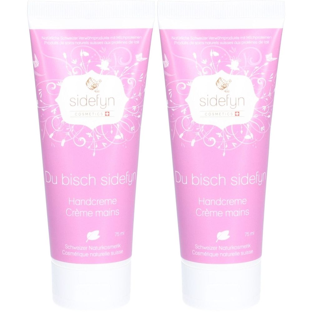 Twee roze handcrèmetubes met witte doppen. Op elke tube staat "sidefyn", "Handcreme" en "Crème mains".