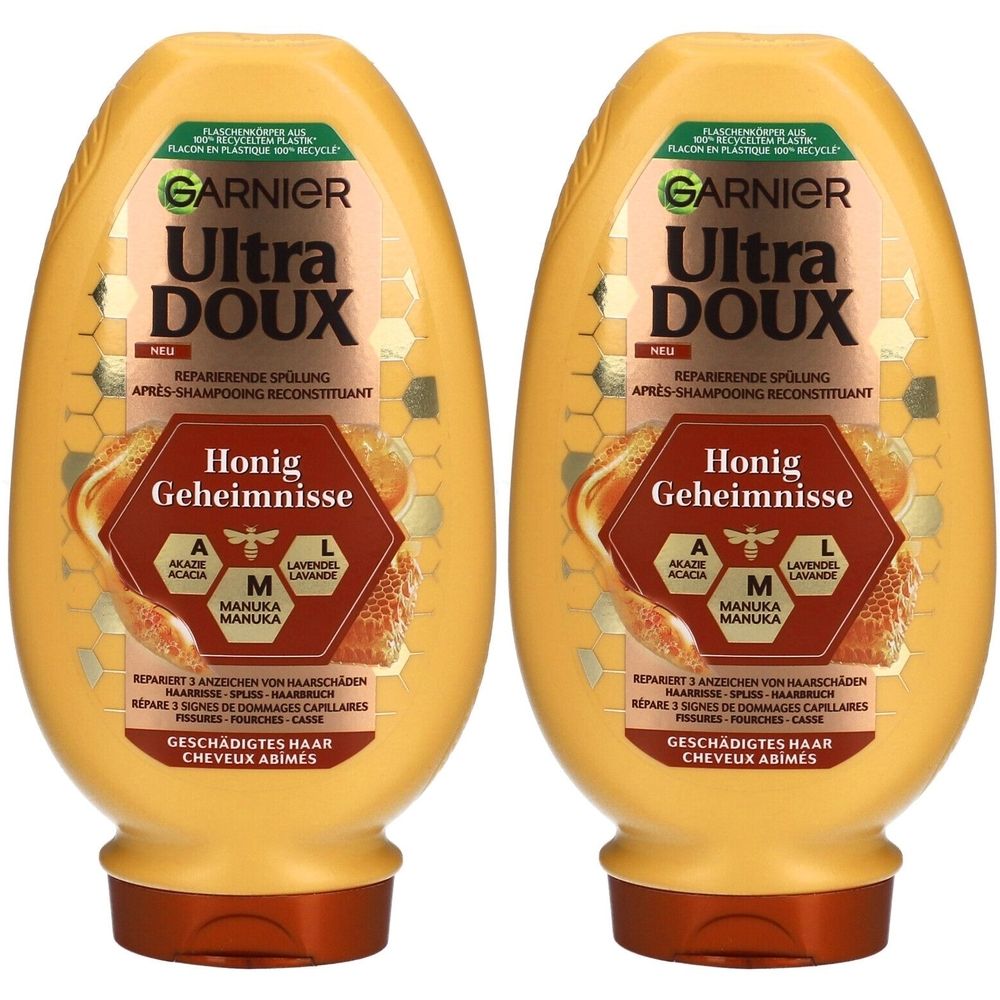 Twee gele flessen met bruine doppen. Opschrift: GARNIER Ultra DOUX Honig Geheimnisse. Tekst in het Duits en Frans.