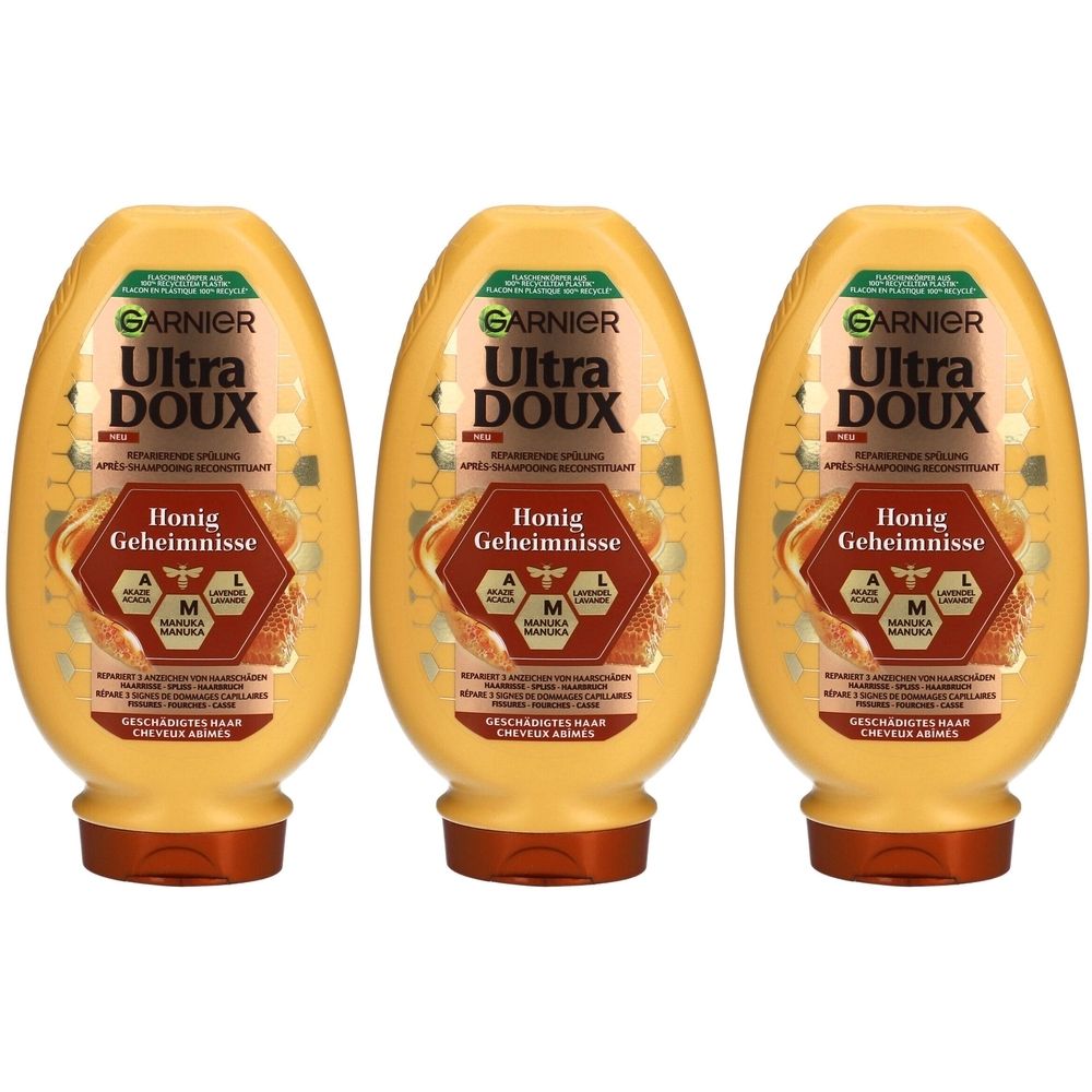 Drie gele flessen met bruine doppen. Op elke fles staat "GARNIER Ultra DOUX Honig Geheimnisse".