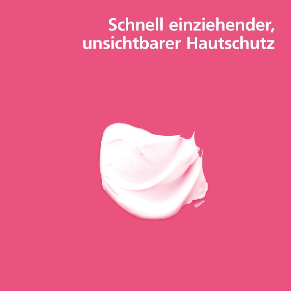 Goutte de crème sur fond rose. Texte : Protection cutanée invisible à absorption rapide.