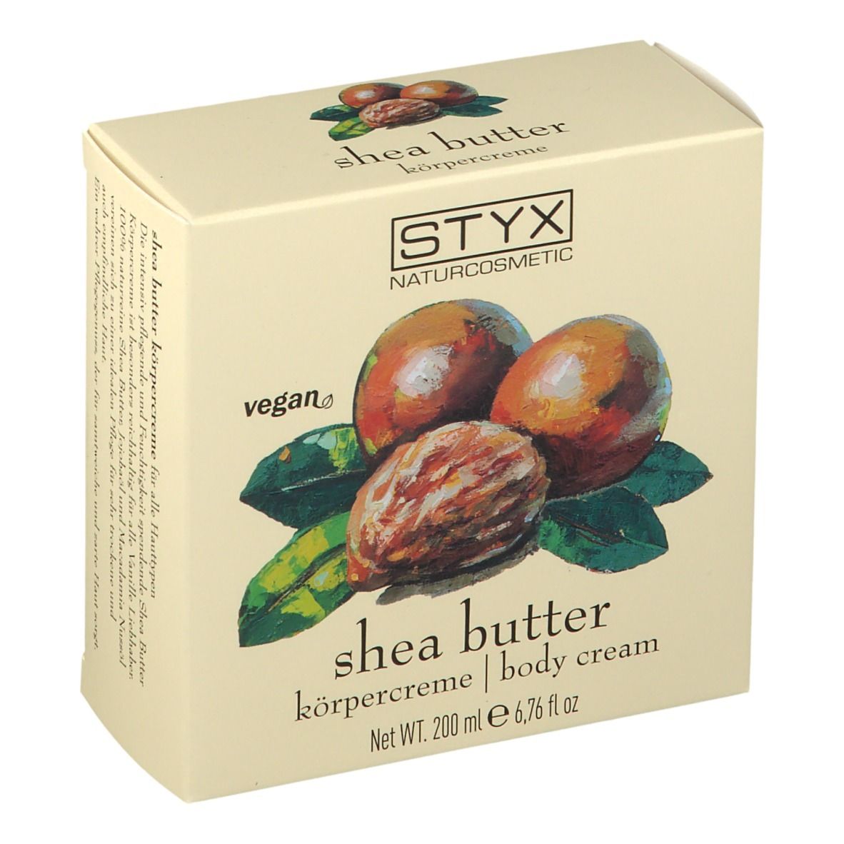 Crèmepot met deksel. Op deksel: STYX, sheabutter bodycrème. Afbeelding van sheanoten en bladeren.