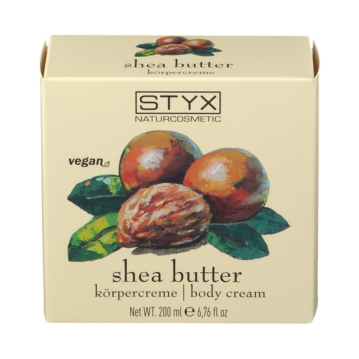 Crèmepot met deksel. Op deksel: STYX, sheabutter bodycrème. Afbeelding van sheanoten en bladeren.