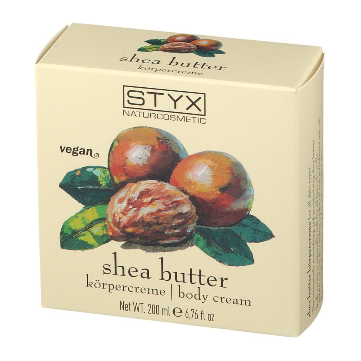 Crèmepot met deksel. Op deksel: STYX, sheabutter bodycrème. Afbeelding van sheanoten en bladeren.