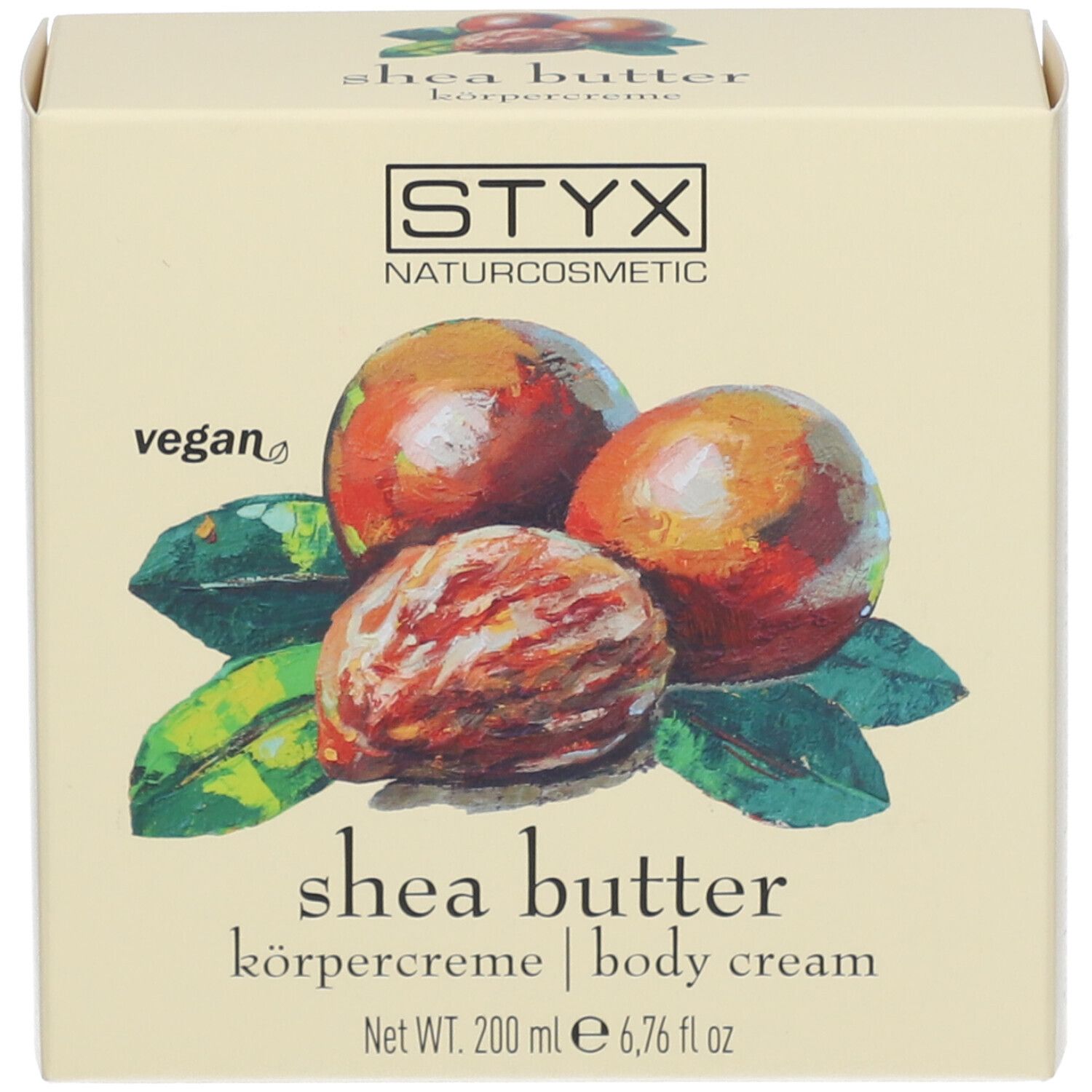Doos met afbeelding van sheanoten en bladeren. Tekst: STYX, sheabutter bodycrème, vegan.