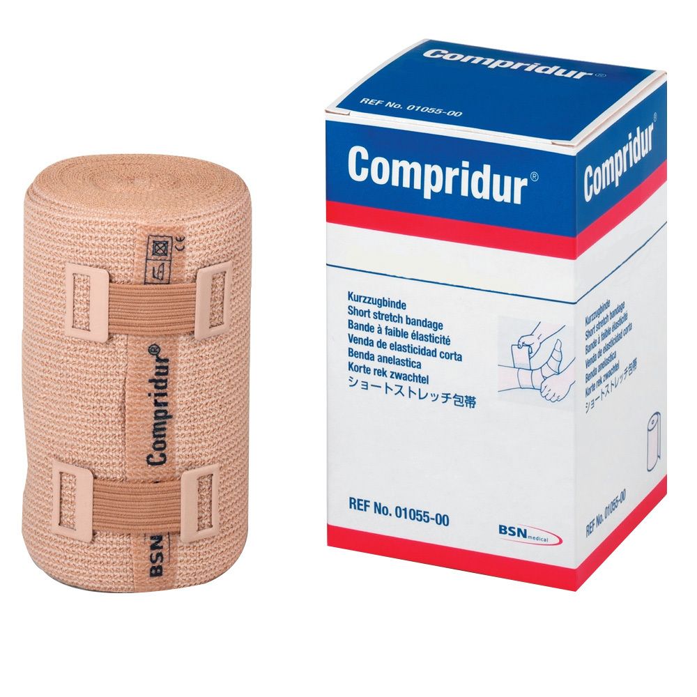 Compressieverband en verpakking. Beige verband met klittenbandsluitingen. Verpakking met productnaam en beschrijving.