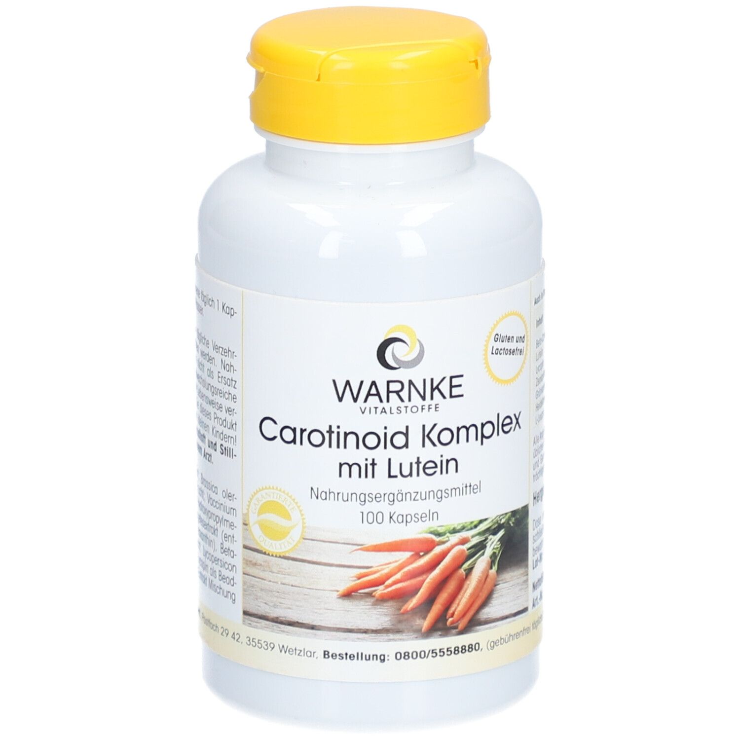 Witte fles met gele dop. Opschrift: WARNKE Vitalstoffe, Carotenoïde Komplex mit Lutein, 100 capsules. Afbeelding van wortelen.
