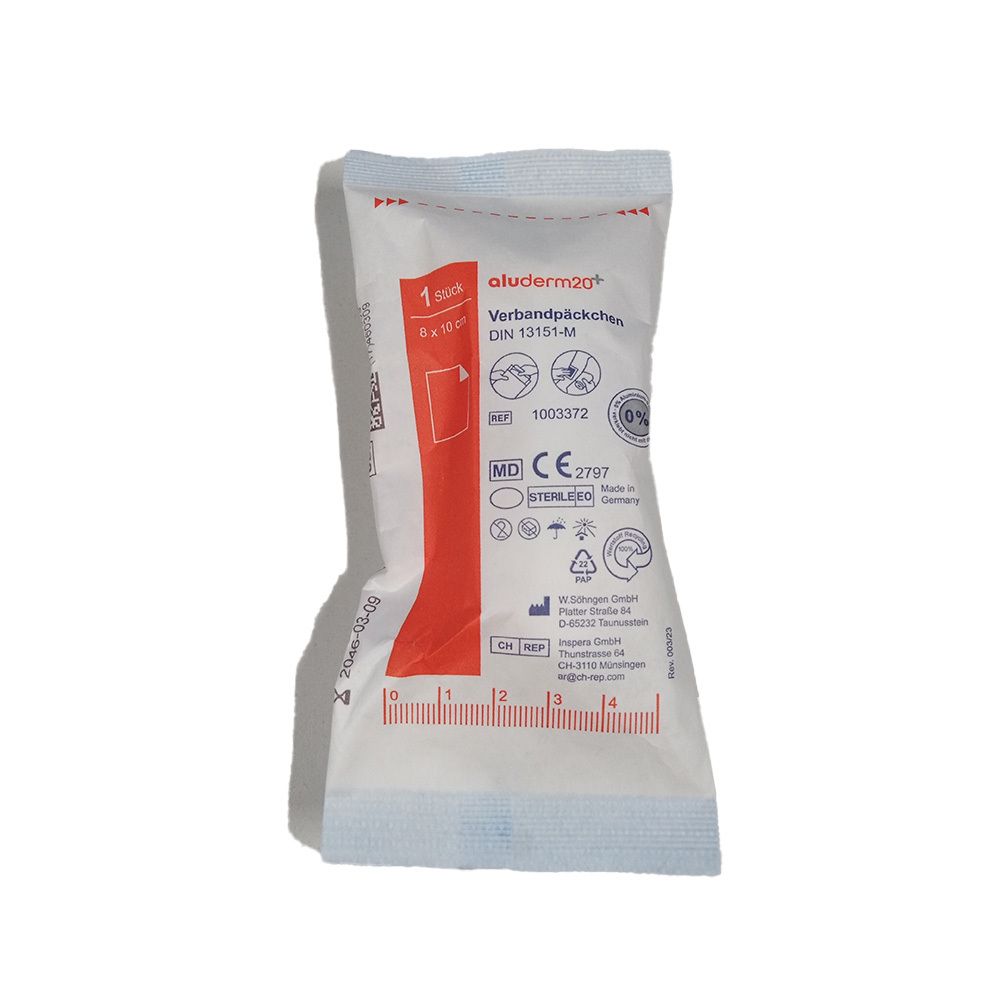 Verbandpakket in witte verpakking. Opschriften: aluderm, DIN 13151-M, CE-markering. Zichtbaar: 6 x 8 cm. Individueel verpakt.