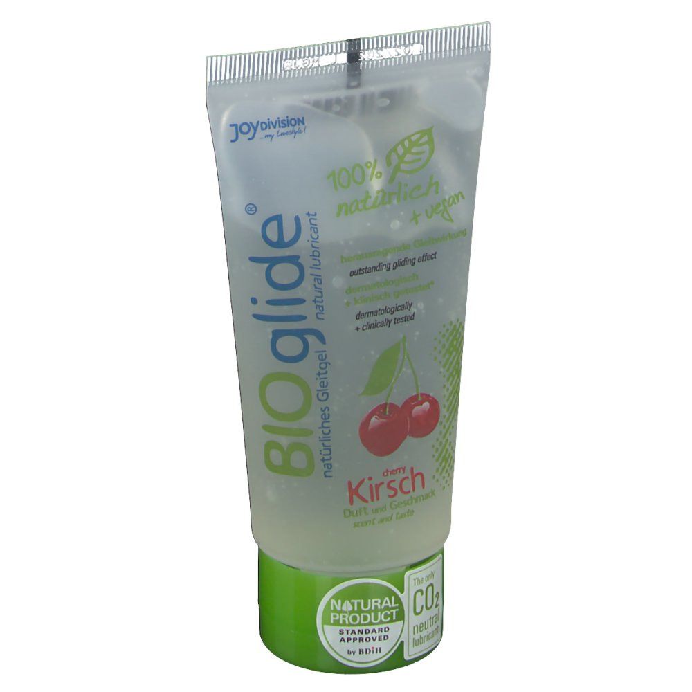 Tube transparent avec bouchon vert. Inscription BIOglide Kirsche, 100% naturel + végétalien. Image de cerises.