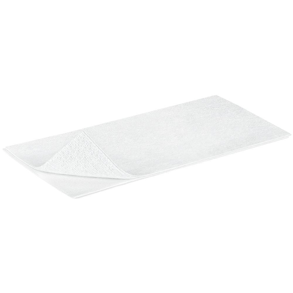 Compresse non tissée blanche, rectangulaire. Pliée. Structure du matériau visible. Taille non spécifiée.