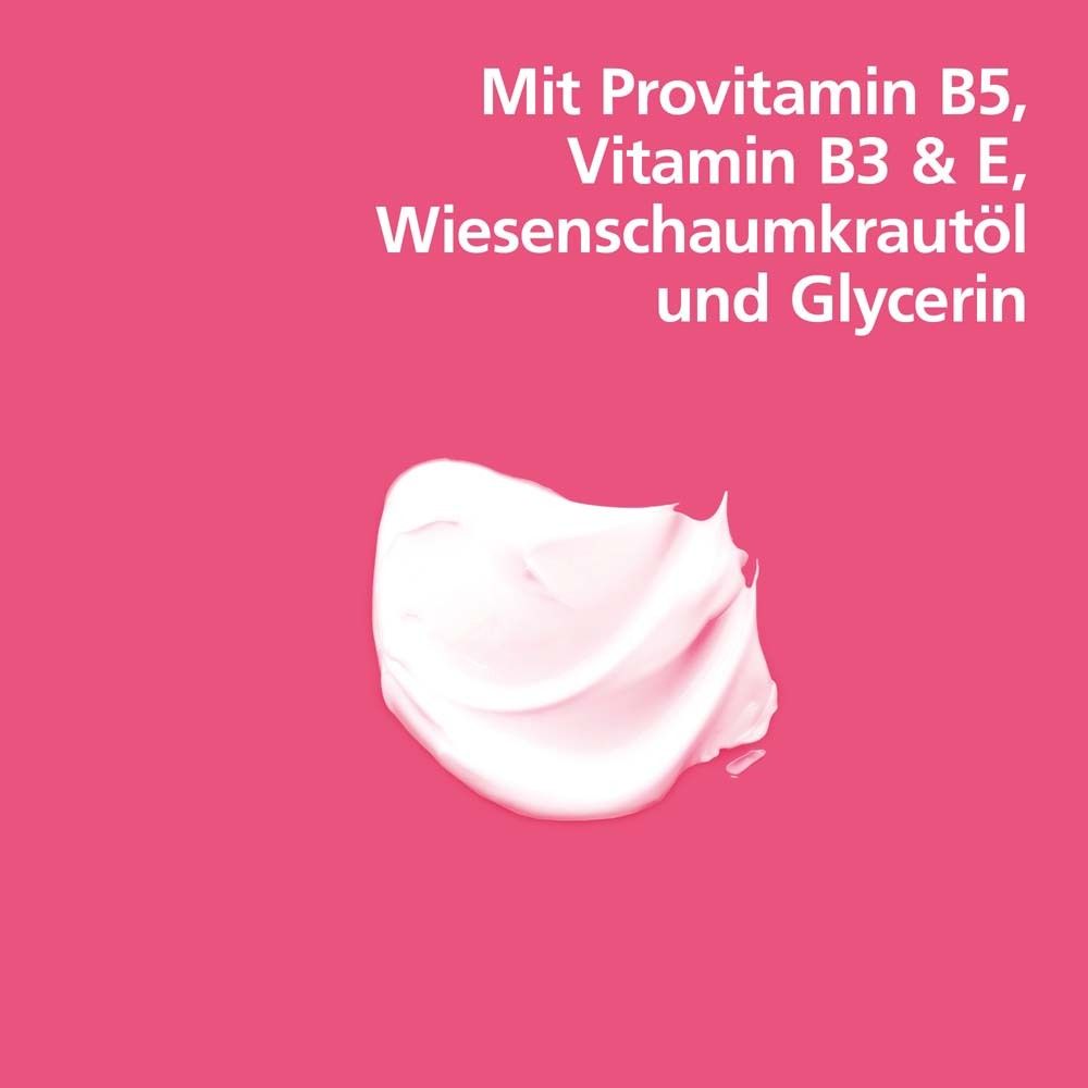 Crème sur fond rose. Texte : Avec provitamine B5, vitamine B3 & E, huile de limnanthe et glycérine.
