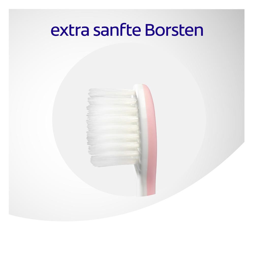 Close-up van de borstelkop van een tandenborstel. Tekst: "extra zachte borstelharen".