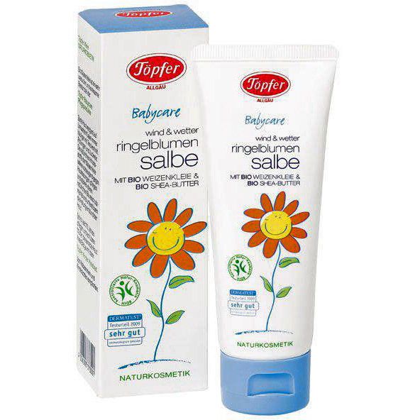 Tube en doos met calendulazalf. Opschrift: Töpfer Babycare, Ringelblumensalbe, Naturkosmetik. Illustratie: bloem met gezicht.