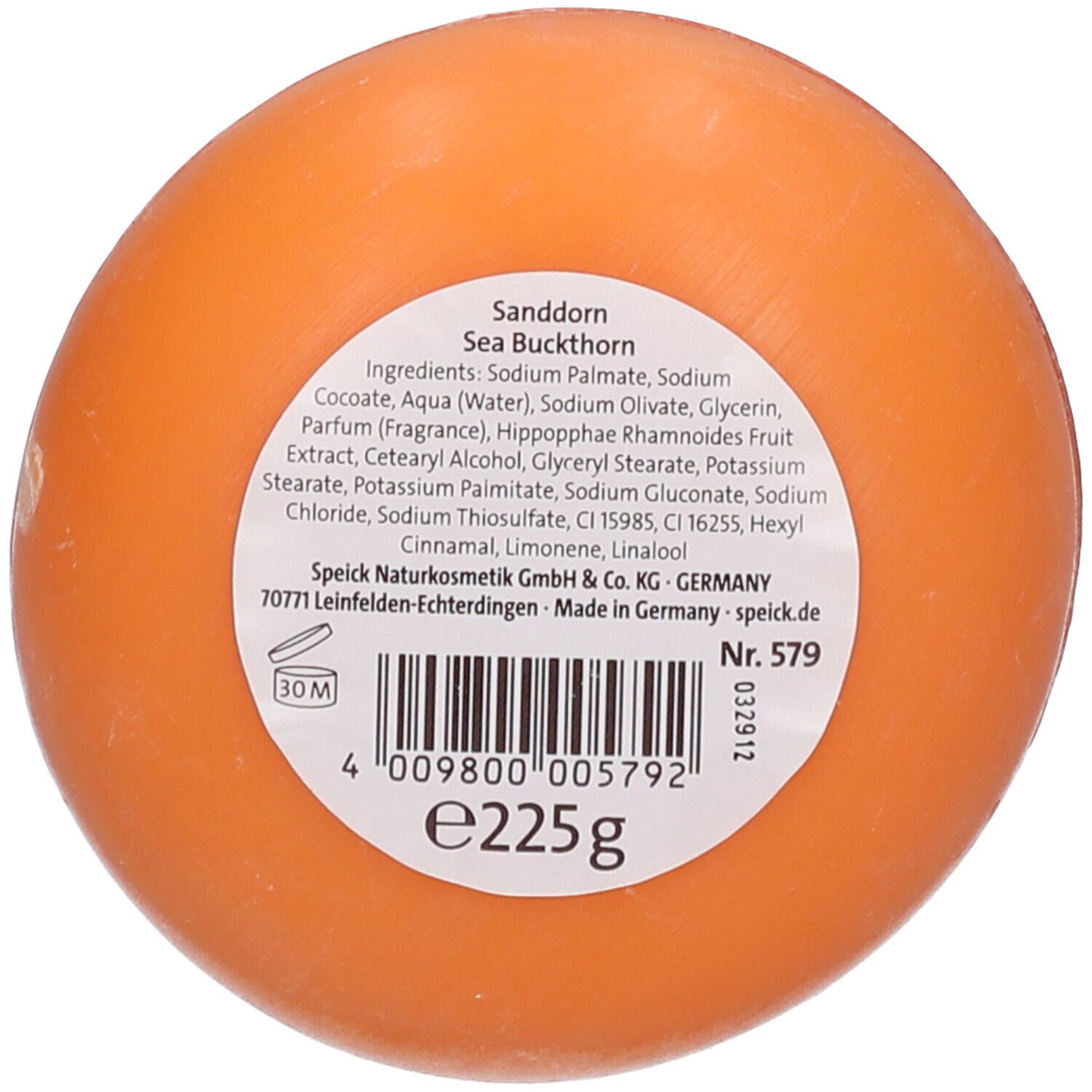 Ronde, oranje zeep. Achterkant met etiket, ingrediënten en barcode.