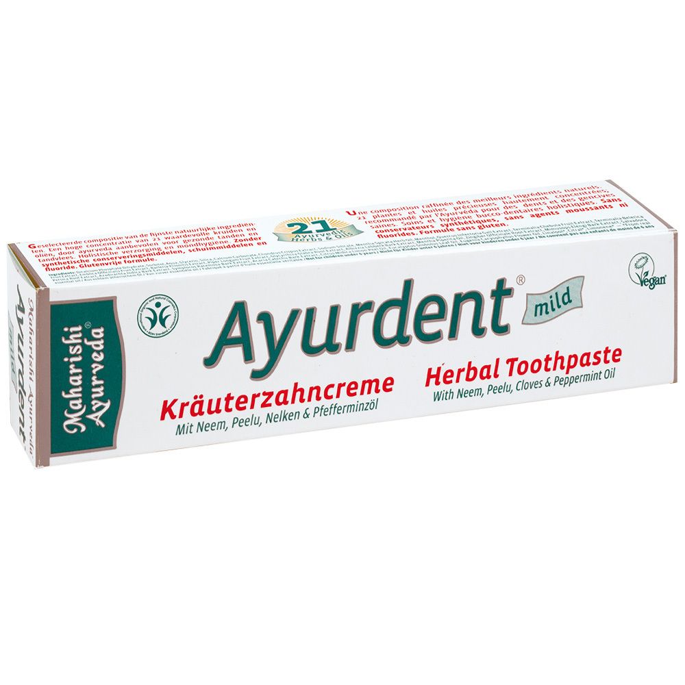 Witte kartonnen doos met Ayurdent mild Kräuterzahncreme. Groene en zwarte logo en tekst. Vegan zegel.