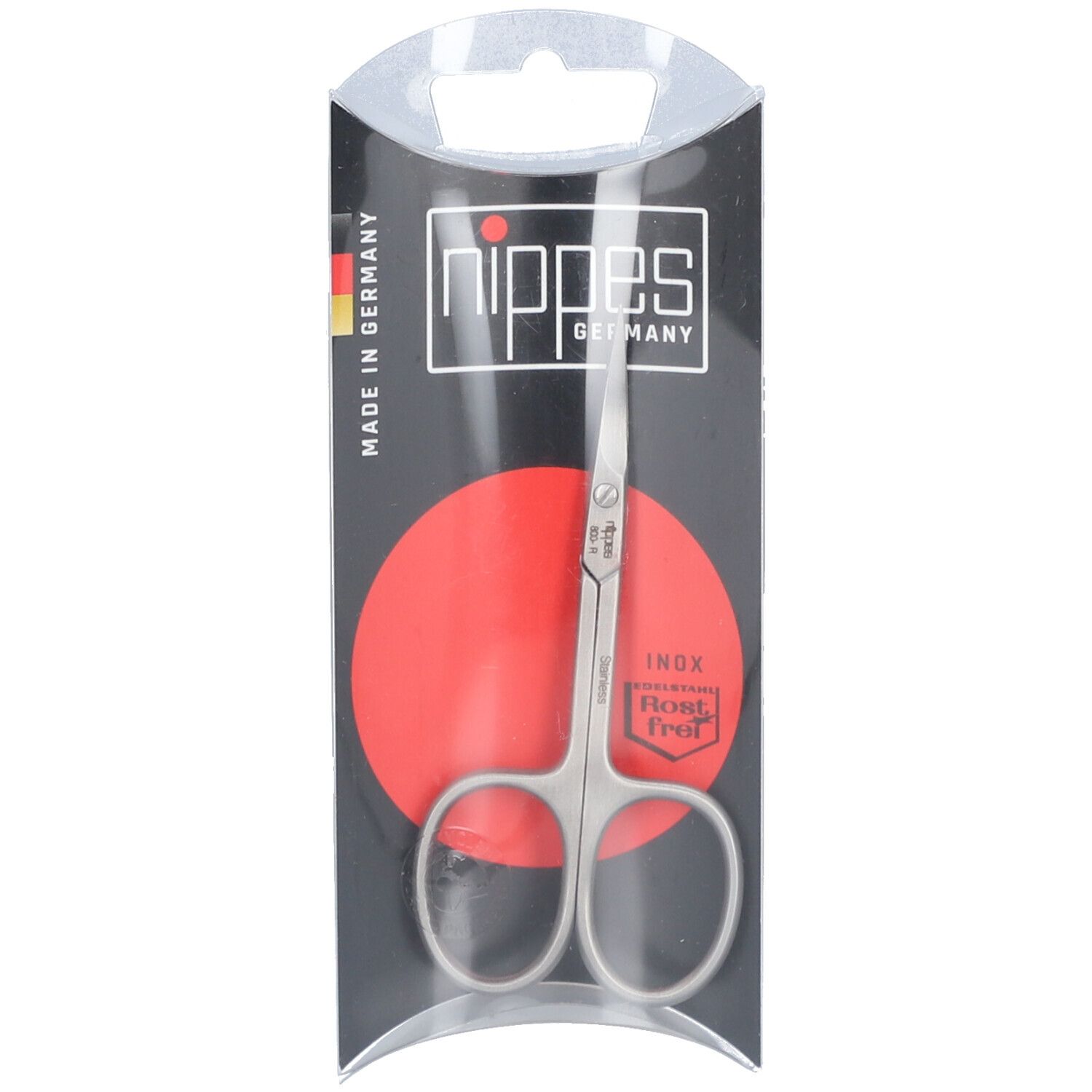 Roestvrije nagelriemschaar in verpakking. Merk Nippes, Made in Germany. Rode cirkel. Inox, roestvrij.