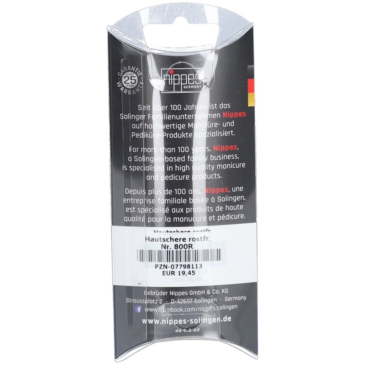 Achterkant van de verpakking. Tekst: Nagelriemschaar roestvrij Nr. 800R. Merk Nippes. Garantie. Made in Germany.