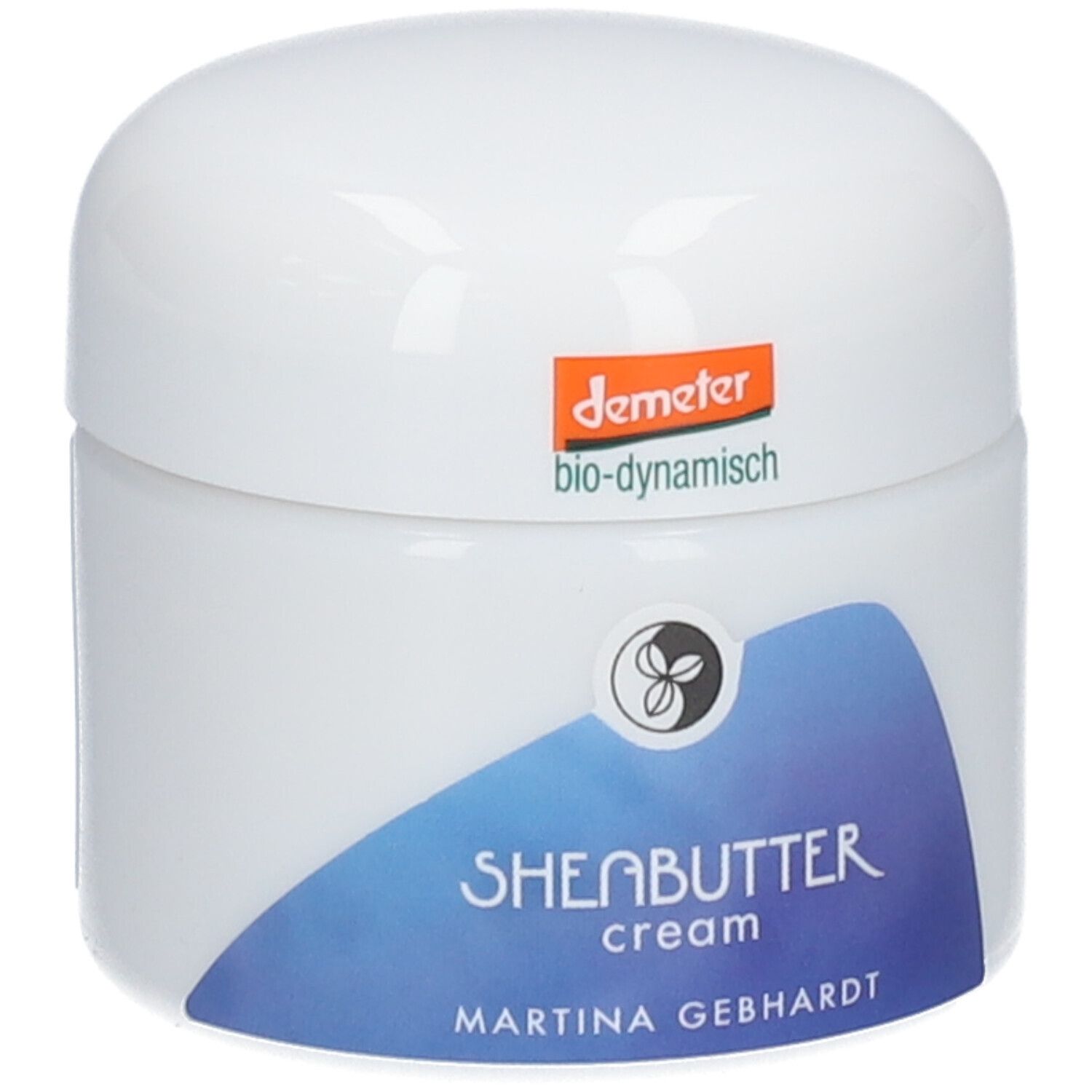 Crème au beurre de karité Martina Gebhardt : pot blanc, étiquette bleue avec inscription 'SHEABUTTER cream'. Sceau Demeter en haut.