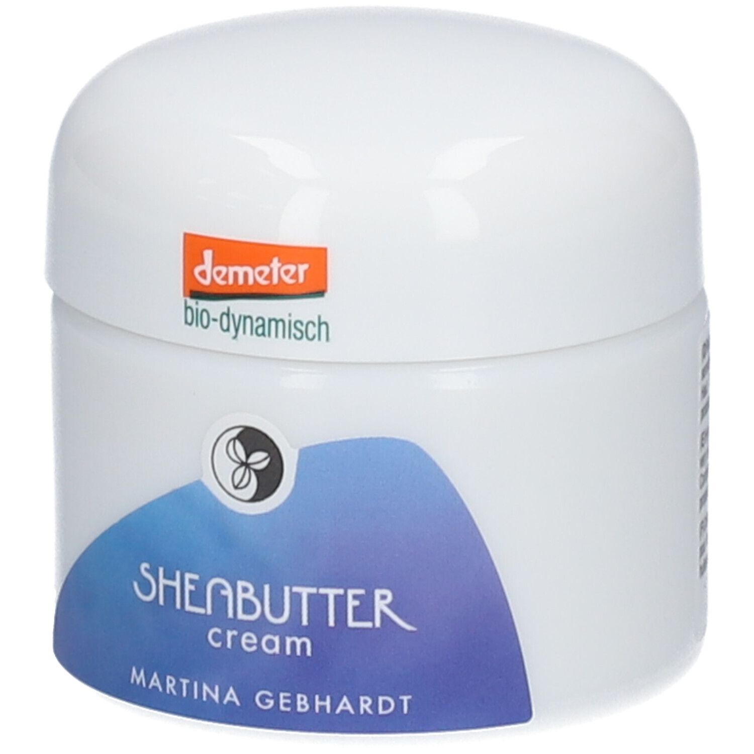 Crème au beurre de karité Martina Gebhardt : pot blanc, étiquette bleue avec inscription 'SHEABUTTER cream'. Sceau Demeter en haut.
