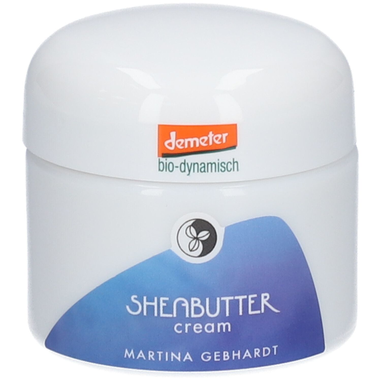 Crème au beurre de karité Martina Gebhardt : pot blanc, étiquette bleue avec inscription 'SHEABUTTER cream'. Sceau Demeter en haut.