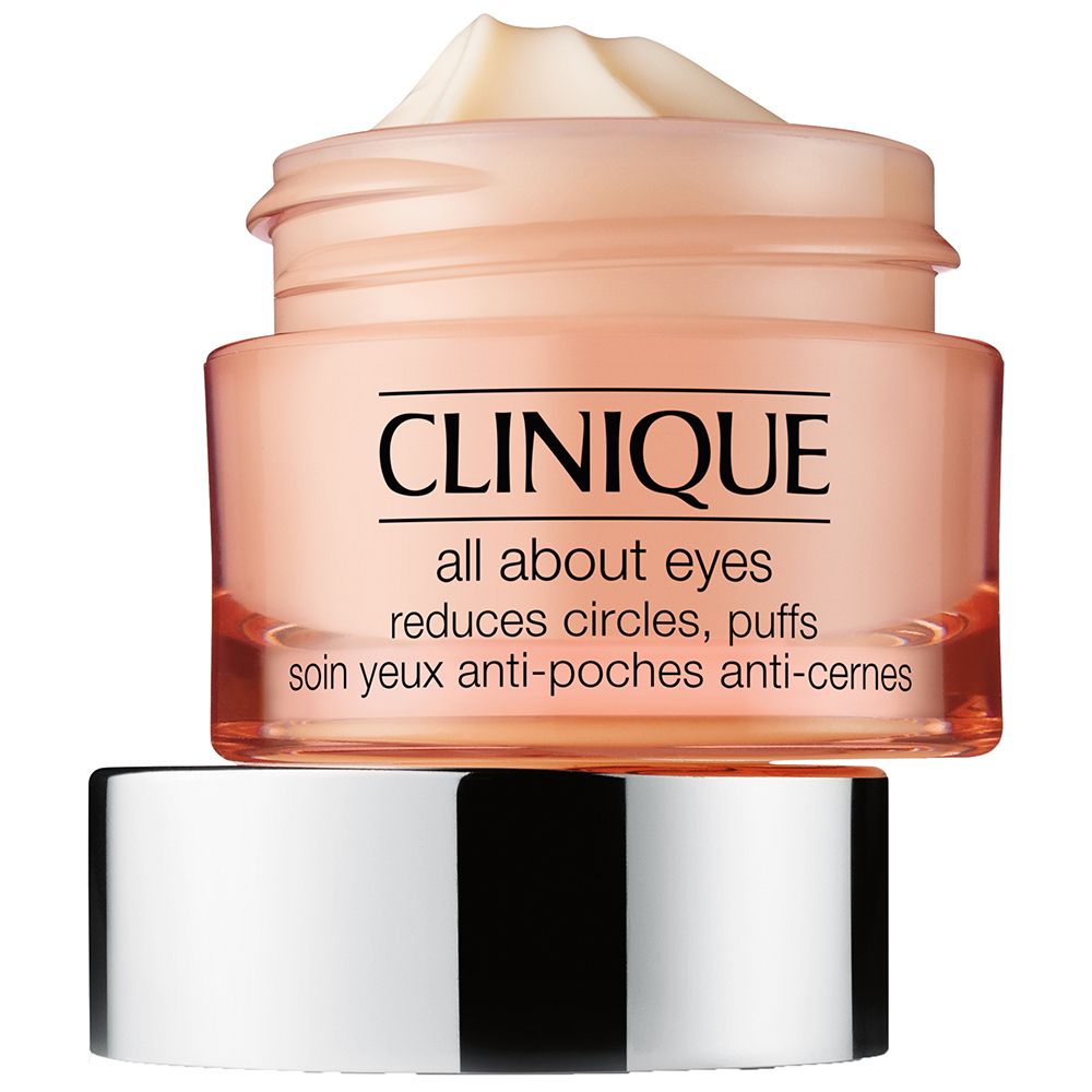 Pot de crème pour les yeux CLINIQUE All About Eyes™. Verre rose, couvercle argenté. Couvercle à côté. Inscription : réduit les cernes, les poches.