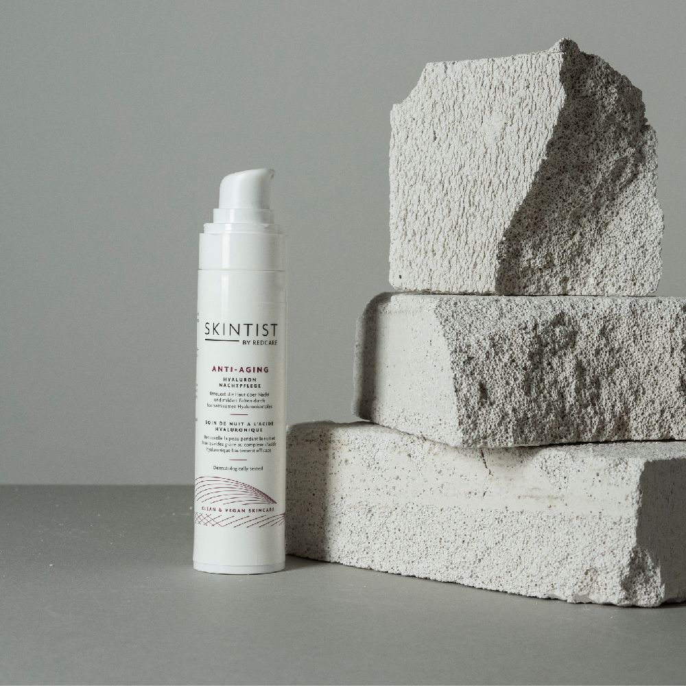 Witte fles met pomp voor stenen blokken. Opschrift: SKINTIST ANTI-AGING Hyaluron Nachtpflege. Dermatologisch getest.