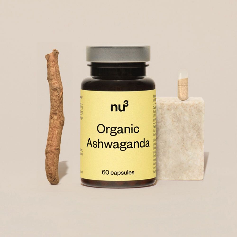 Een fles nu3 Organic Ashwagandha, een capsule en een stuk ashwagandha-wortel.