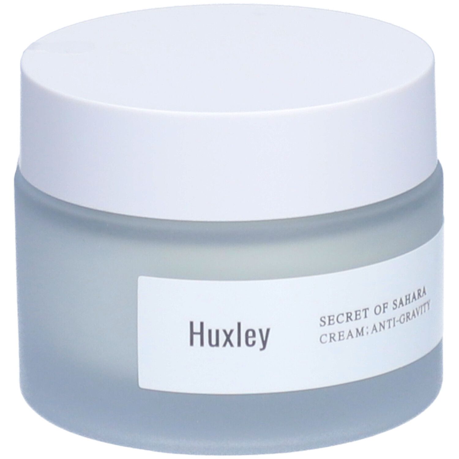 Pot de crème avec couvercle blanc. Étiquette avec 'Huxley' et 'Secret of Sahara Cream: Anti-Gravity'.