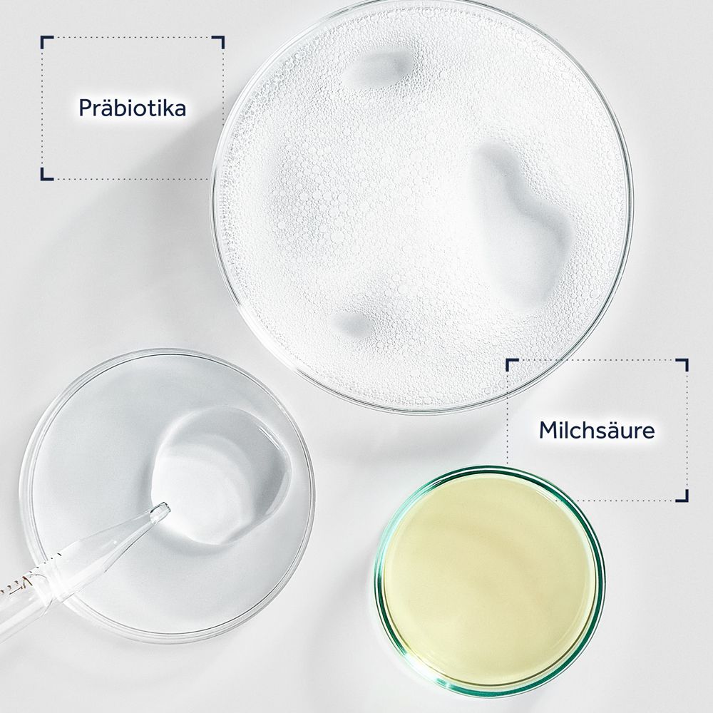 Trois boîtes de Pétri contenant des probiotiques, de l'acide lactique et un liquide jaune.